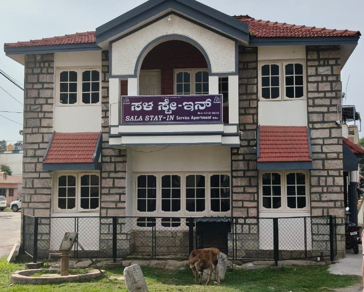 Sala Stay In service apartment building with name board on Kanakadasa Street, Belur