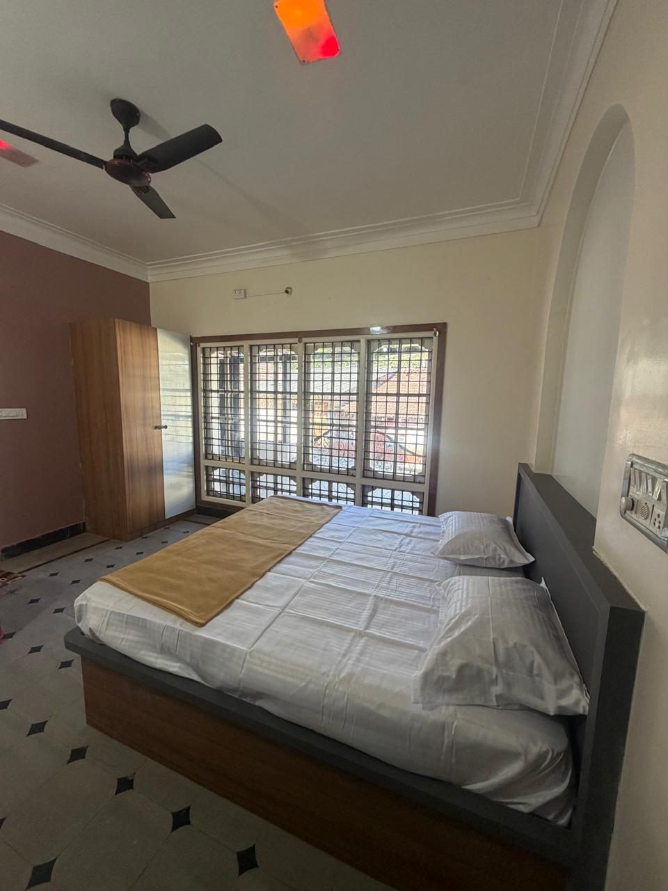 Room with double bed and window at Sala Stay In, Belur
